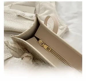 Detail view of smooth metal zipper and lace trim on a straw beach tote bag