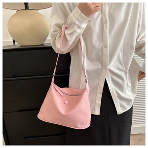 Pink nylon dumpling bag shoulder strap close-up and waterproof texture details