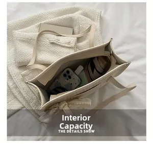 Detail view of large straw beach bag interior capacity with phone and umbrella
