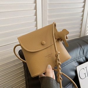 Brown litchi grain shoulder bag with elegant flap cover and cute elephant pendant