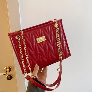 Classic red quilted shoulder bag with gold chain strap and stylish turn-lock closure