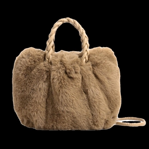 Brown fluffy plush handbag with woven top handle against a solid black background