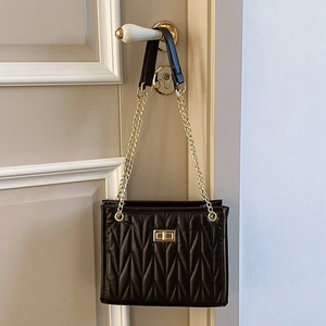 Classic black quilted shoulder bag with gold chain strap and square twist lock closure