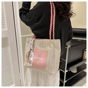 Detail of summer woven tote bag with pink straps and Summer logo on woman shoulder