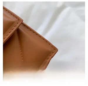 Detailed close-up of brown leather bag featuring quilted stitching and premium craftsmanship