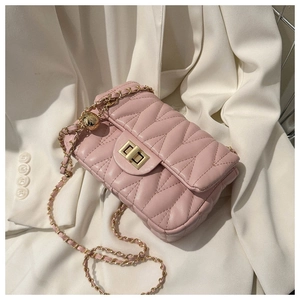 Detail of light pink chevron quilted bag featuring gold chain and signature metal ball buckle