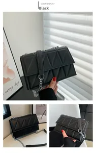 Detail of black quilted crossbody bag with 3D triangle pattern and silver chain strap