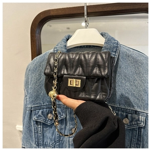 Detail of black quilted leather crossbody bag with gold lock and chain strap