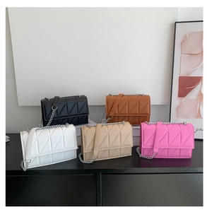 Detailed shot of quilted flap chain bags in black brown white beige and pink colors