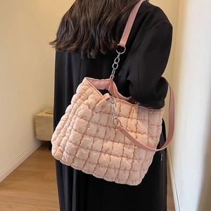 Pink quilted bubble tote bag with silver chain strap shown as a casual shoulder bag