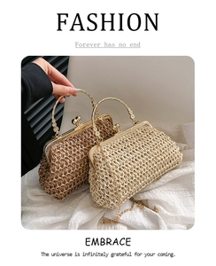 Detail of handmade woven straw clutch featuring vintage carved metal handles and chain strap