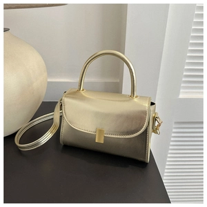 Detailed close-up of champagne gold mini crossbody bag with metallic faux leather and clasp