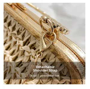 Detail of detachable gold chain strap with lobster clasp on beige woven handbag
