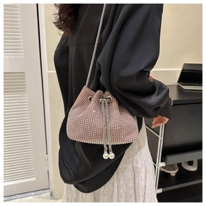 Detail of pink rhinestone bucket bag with pearl drawstring and silver chain strap