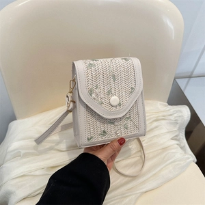 Minimalist cream mini crossbody bag featuring green leaf embroidery and V-cut flap design