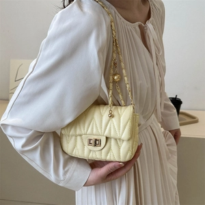 Quilted beige crossbody chain bag with chevron stitching and adjustable gold ball strap
