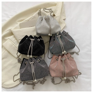 Detail of rhinestone bucket bags with chain straps and pearl drawstring accents