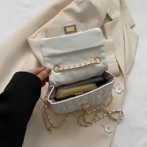 White quilted crossbody chain bag showing internal capacity for phone and wallet