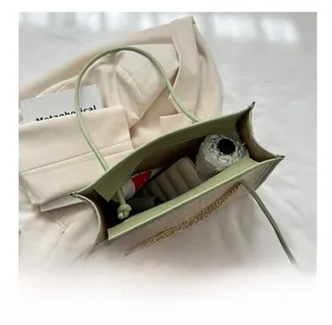Interior view of light green straw tote bag showing spacious capacity for daily essentials