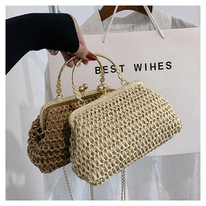 Detailed macro view of handmade straw bags with gold metal clasps and round handles