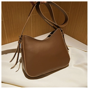 Vue détaillée du sac à épaule en cuir marron avec coutures fines et bandoulière réglable
