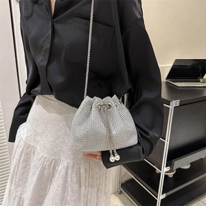 Sparkly silver rhinestone bucket bag with chain strap and elegant pearl drawstrings
