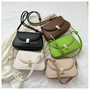 Top view of compact saddle bags in five colors with golden turn-locks and knot straps