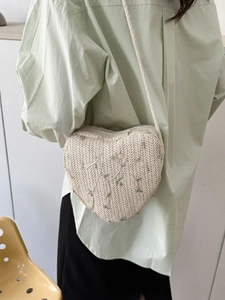 Woven heart-shaped straw crossbody bag with floral embroidery for summer vacation style