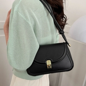 Classic black vintage saddle bag with gold swivel lock and elegant leather shoulder strap