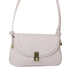 Elegant vintage saddle bag in soft beige faux leather with golden rotary clasp on white base