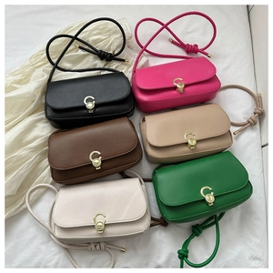 Flat lay of vintage style underarm bags in six colors with gold C-shaped metal buckles