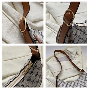 Detail of vintage crescent bag showing clover pattern fabric and gold metal zipper