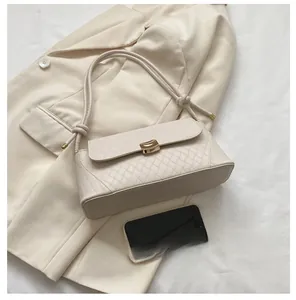 Detailed size comparison of beige quilted leather shoulder bag with a smartphone