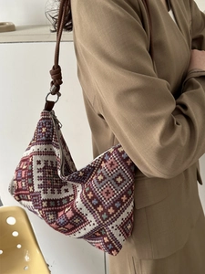 Ethnic woven hobo shoulder bag featuring retro geometric patterns and leather straps