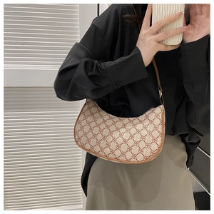 Mirror selfie showing the retro monogram crescent bag worn on shoulder as an underarm bag