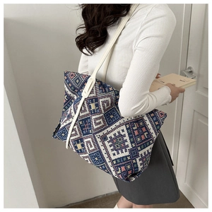 Close-up of geometric pattern jacquard tote bag with stylish shoulder straps