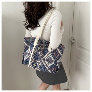 Detailed close-up of a large ethnic canvas tote bag with vibrant geometric patterns