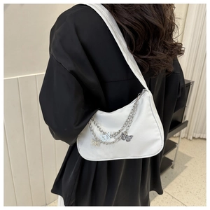 White nylon underarm bag featuring decorative silver metal chains and butterfly charms