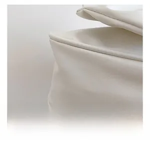 Close-up of white leather texture and fine stitching on the bow pearl chain bag