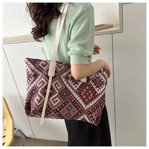 Ethnic style woven tote bag with geometric patterns and long shoulder straps