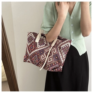 Detailed view of ethnic canvas tote bag with colorful geometric woven diamond patterns