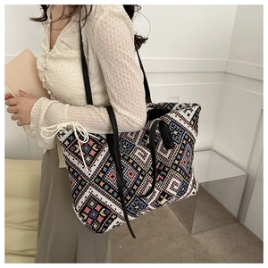 Close-up of ethnic geometric pattern canvas tote bag with leather straps and drawstring
