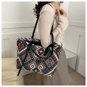 Ethnic style woven canvas tote bag shown on shoulder highlighting large capacity