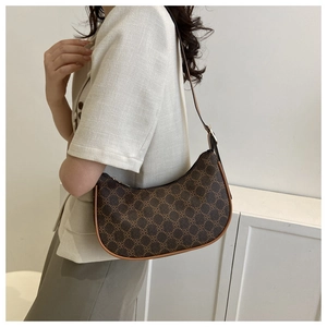 Detailed view of a vintage brown monogram crescent hobo bag with adjustable strap
