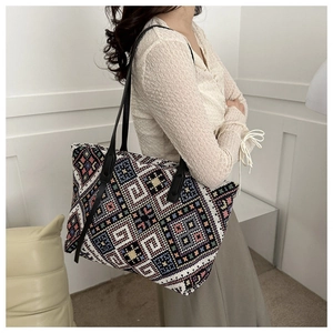 Detailed close-up of ethnic woven canvas tote bag with colorful geometric patterns