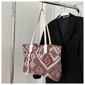 Detailed close-up of large ethnic canvas tote bag with multi-color geometric weave pattern
