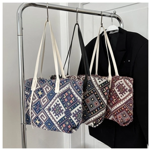 Detailed view of ethnic geometric pattern woven tote bags in three distinct colorways