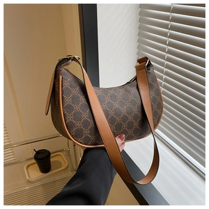 Detail of vintage brown monogram crescent hobo bag with adjustable leather strap