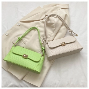 Detail of baguette shoulder bags with quilted texture and golden metal buckle closure