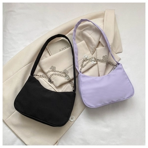 Detail of hobo underarm bags in black and lavender with butterfly metal chain decoration